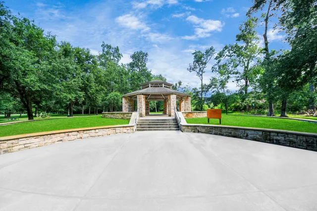 a front view of a house with yard and green space