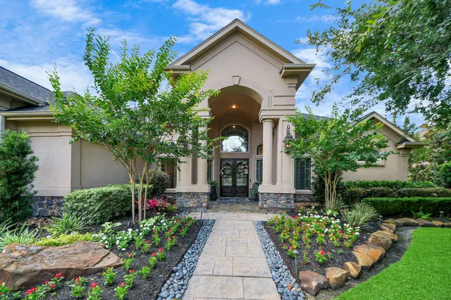 a front view of a house with garden