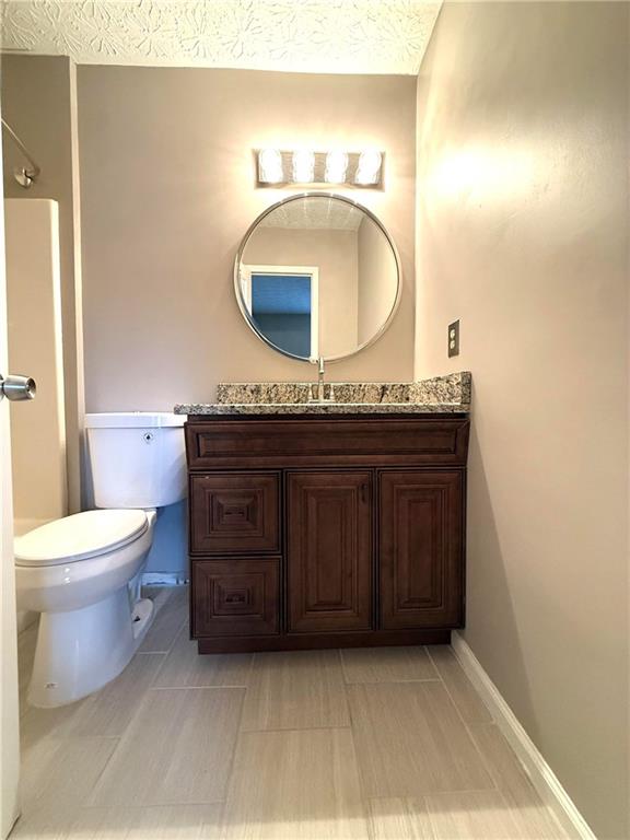 1555 Springleaf Court Southeast Smyrna, GA 30080 - Photo 11 of 19 a bathroom with a granite countertop sink and a mirror