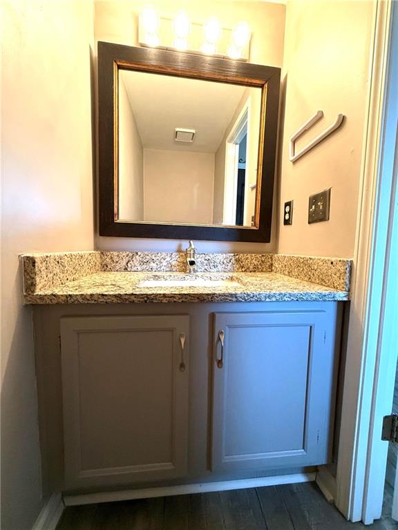 1555 Springleaf Court Southeast Smyrna, GA 30080 - Photo 18 of 19 a bathroom with a granite countertop sink and a mirror