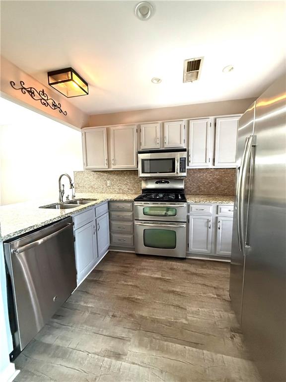 1555 Springleaf Court Southeast Smyrna, GA 30080 - Photo 4 of 19 a kitchen with a sink appliances and cabinets