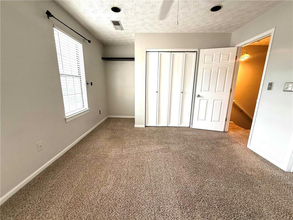 1555 Springleaf Court Southeast Smyrna, GA 30080 - Photo 10 of 19 an empty room with windows and closet