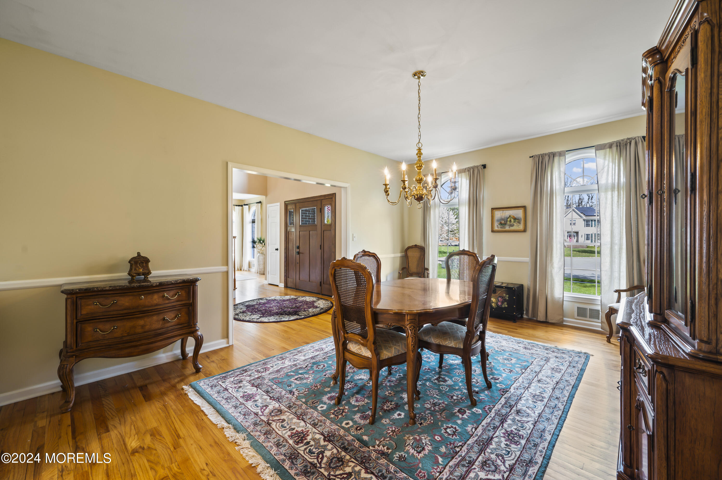2805 Newman Way Wall, NJ 07719 - Photo 15 of 31 a dining room with furniture a rug and a chandelier