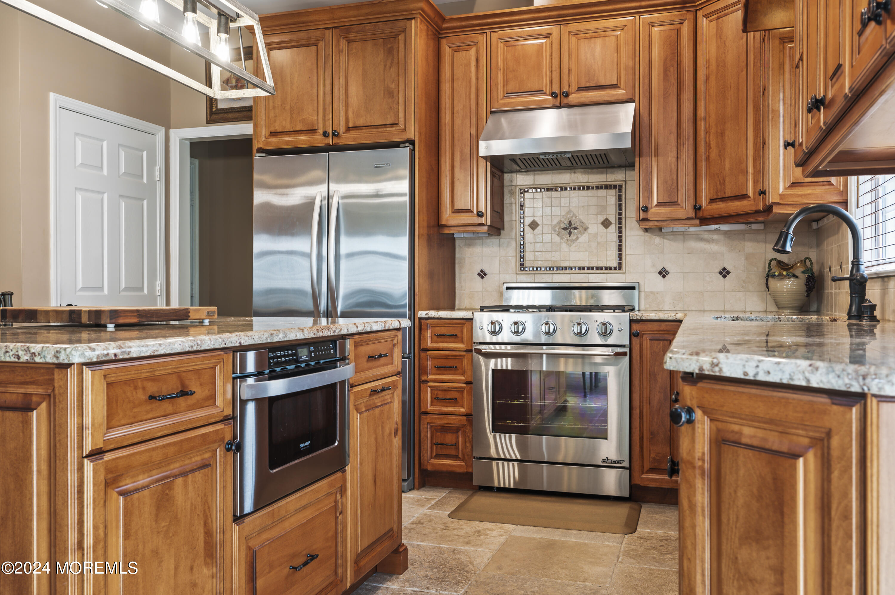 2805 Newman Way Wall, NJ 07719 - Photo 9 of 31 a kitchen with stainless steel appliances granite countertop a stove and a refrigerator