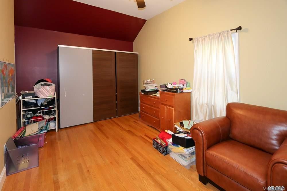 80-76 Springfield Boulevard Queens, NY 11427 - Photo 12 of 21 a bedroom with a bed and a couch