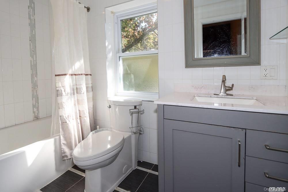 80-76 Springfield Boulevard Queens, NY 11427 - Photo 13 of 21 a bathroom with a toilet sink and mirror