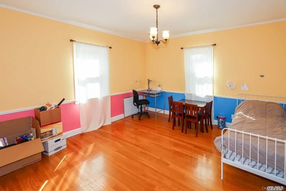 80-76 Springfield Boulevard Queens, NY 11427 - Photo 16 of 21 a view of a dining room with furniture and chandelier