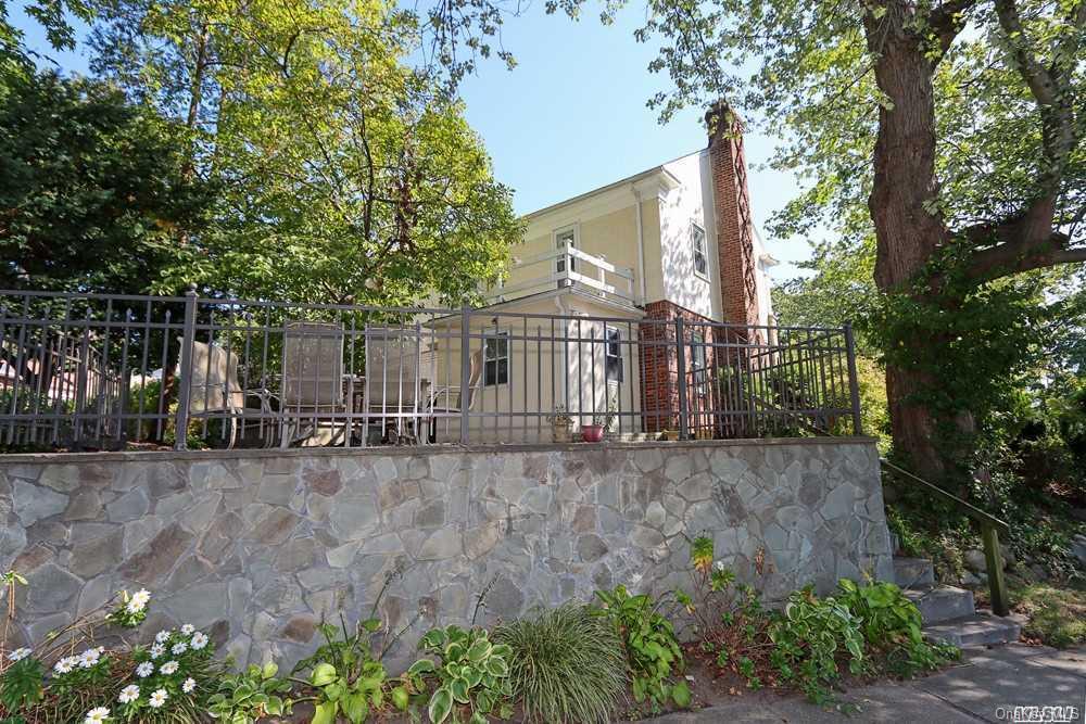 80-76 Springfield Boulevard Queens, NY 11427 - Photo 21 of 21 a view of a house with large tree and wooden fence