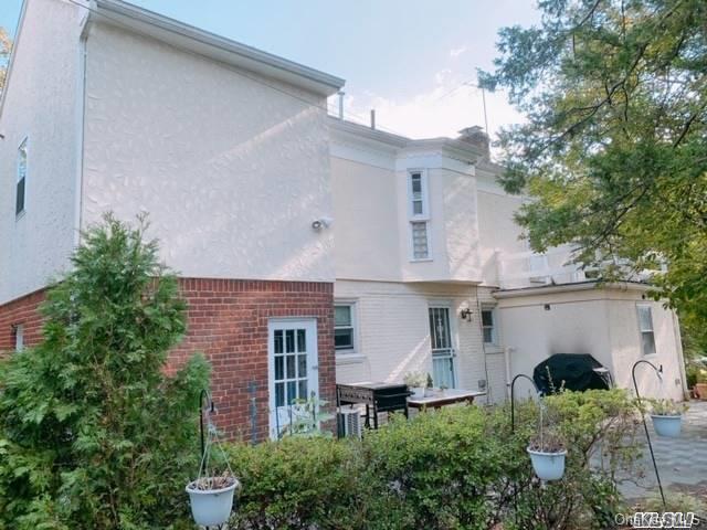 80-76 Springfield Boulevard Queens, NY 11427 - Photo 3 of 21 a aerial view of a house with table and chairs under an umbrella