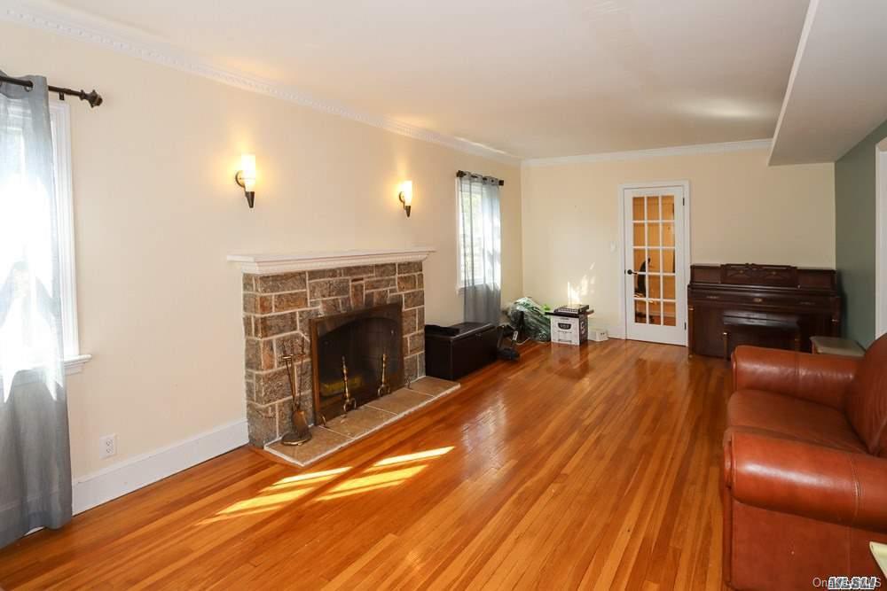 80-76 Springfield Boulevard Queens, NY 11427 - Photo 5 of 21 a living room with furniture and a fireplace