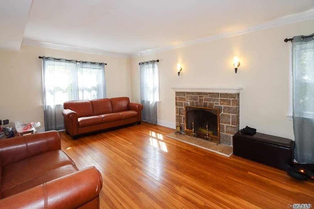 80-76 Springfield Boulevard Queens, NY 11427 - Photo 6 of 21 a living room with furniture and a fireplace