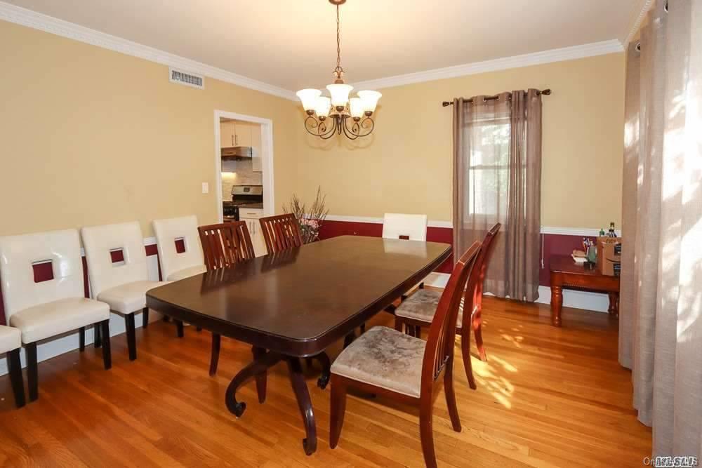80-76 Springfield Boulevard Queens, NY 11427 - Photo 7 of 21 a view of a dining room with furniture and wooden floor
