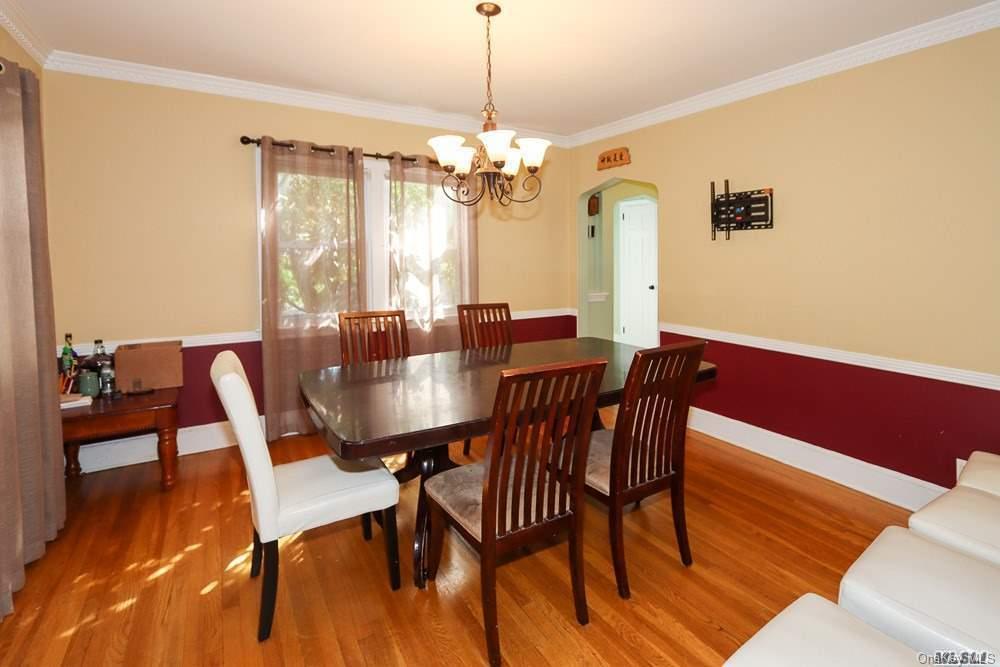 80-76 Springfield Boulevard Queens, NY 11427 - Photo 8 of 21 a dining room with furniture a chandelier and wooden floor