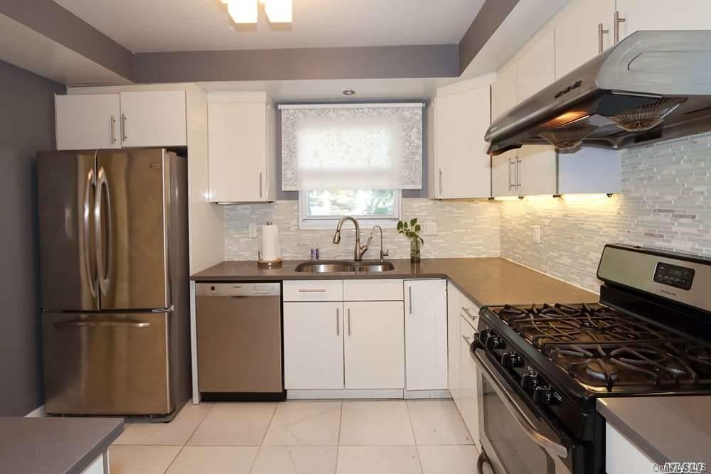 80-76 Springfield Boulevard Queens, NY 11427 - Photo 9 of 21 a kitchen with granite countertop a stove sink and refrigerator