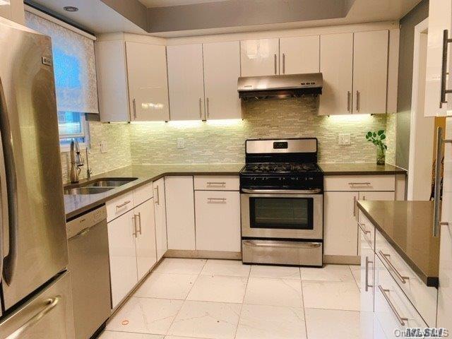 80-76 Springfield Boulevard Queens, NY 11427 - Photo 10 of 21 a kitchen with granite countertop a stove and a refrigerator