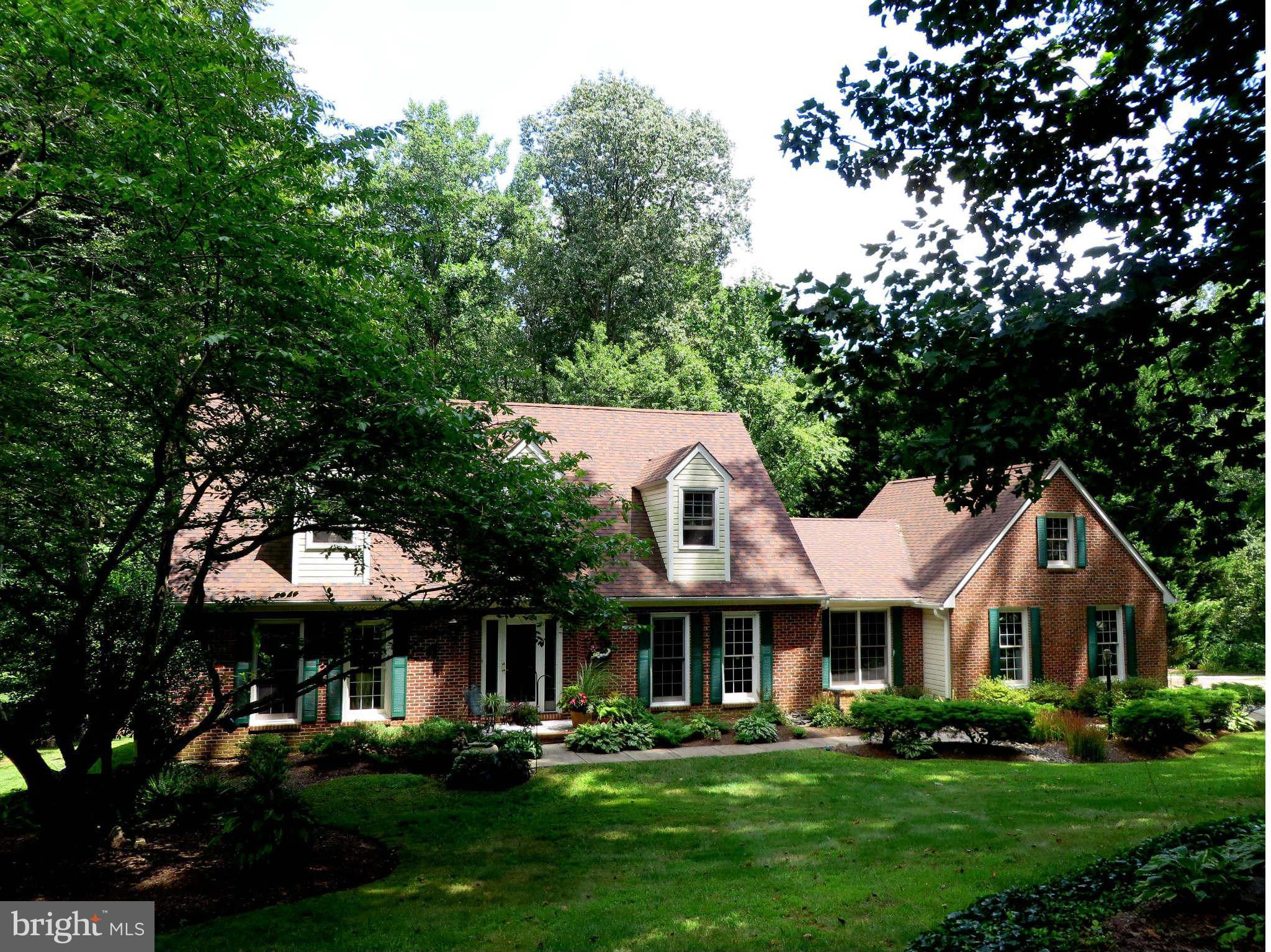 24 Elmridge Road Arnold, MD 21012 - Photo 1 of 30 a front view of a house with a garden and trees