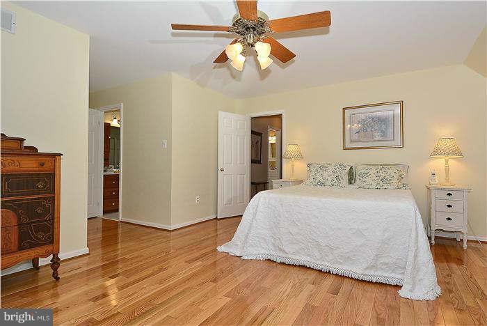 24 Elmridge Road Arnold, MD 21012 - Photo 16 of 30 a bedroom with a bed and wooden floor