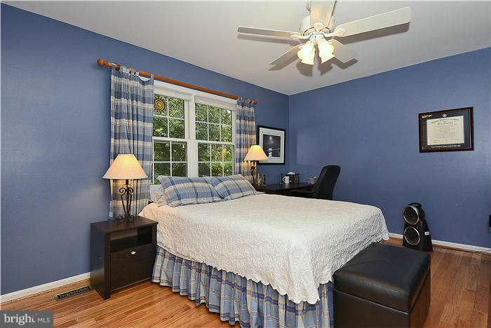 24 Elmridge Road Arnold, MD 21012 - Photo 18 of 30 a bedroom with a bed and a chandelier