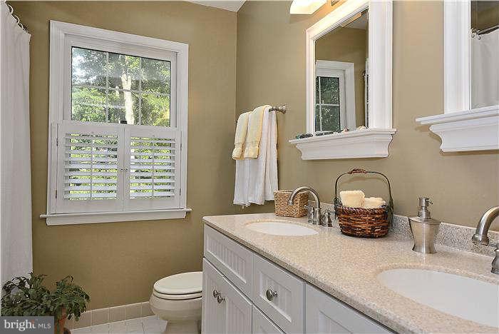 24 Elmridge Road Arnold, MD 21012 - Photo 20 of 30 a bathroom with a double vanity sink toilet and a window