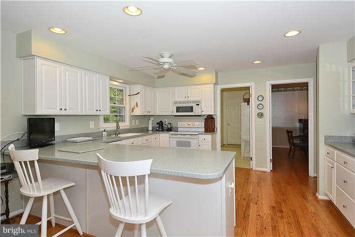 24 Elmridge Road Arnold, MD 21012 - Photo 8 of 30 a kitchen with a dining table chairs refrigerator and sink