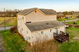 a view of a house with a yard and sitting area