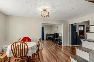 a dining room with furniture entryway and wooden floor