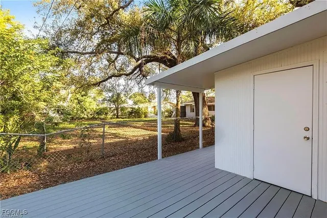 a view of a hardwood & an empty room with wooden floor
