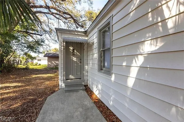 a view of a house with a large tree