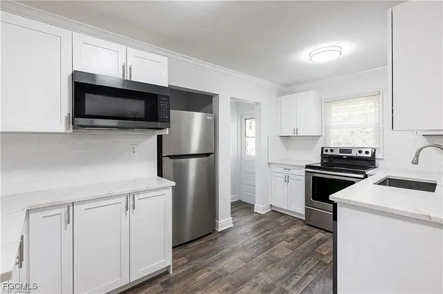 a kitchen with a refrigerator stove and microwave