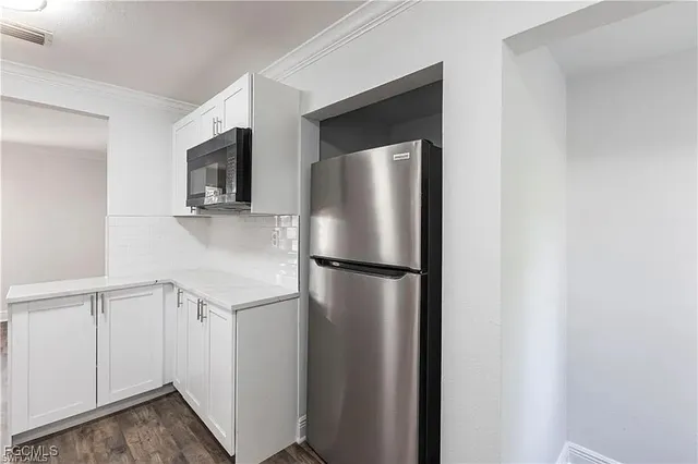 a white refrigerator freezer sitting in a kitchen