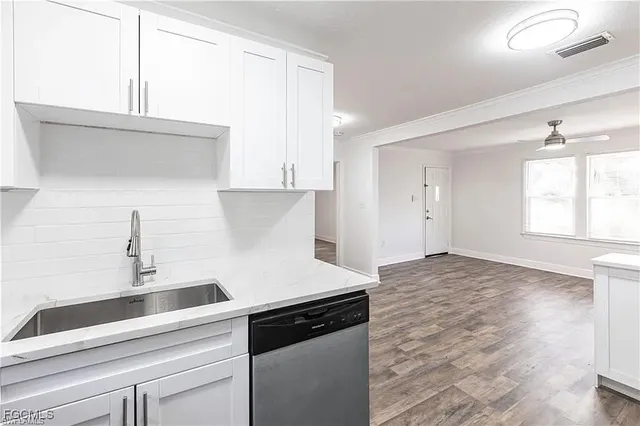 a kitchen with a sink cabinets and window