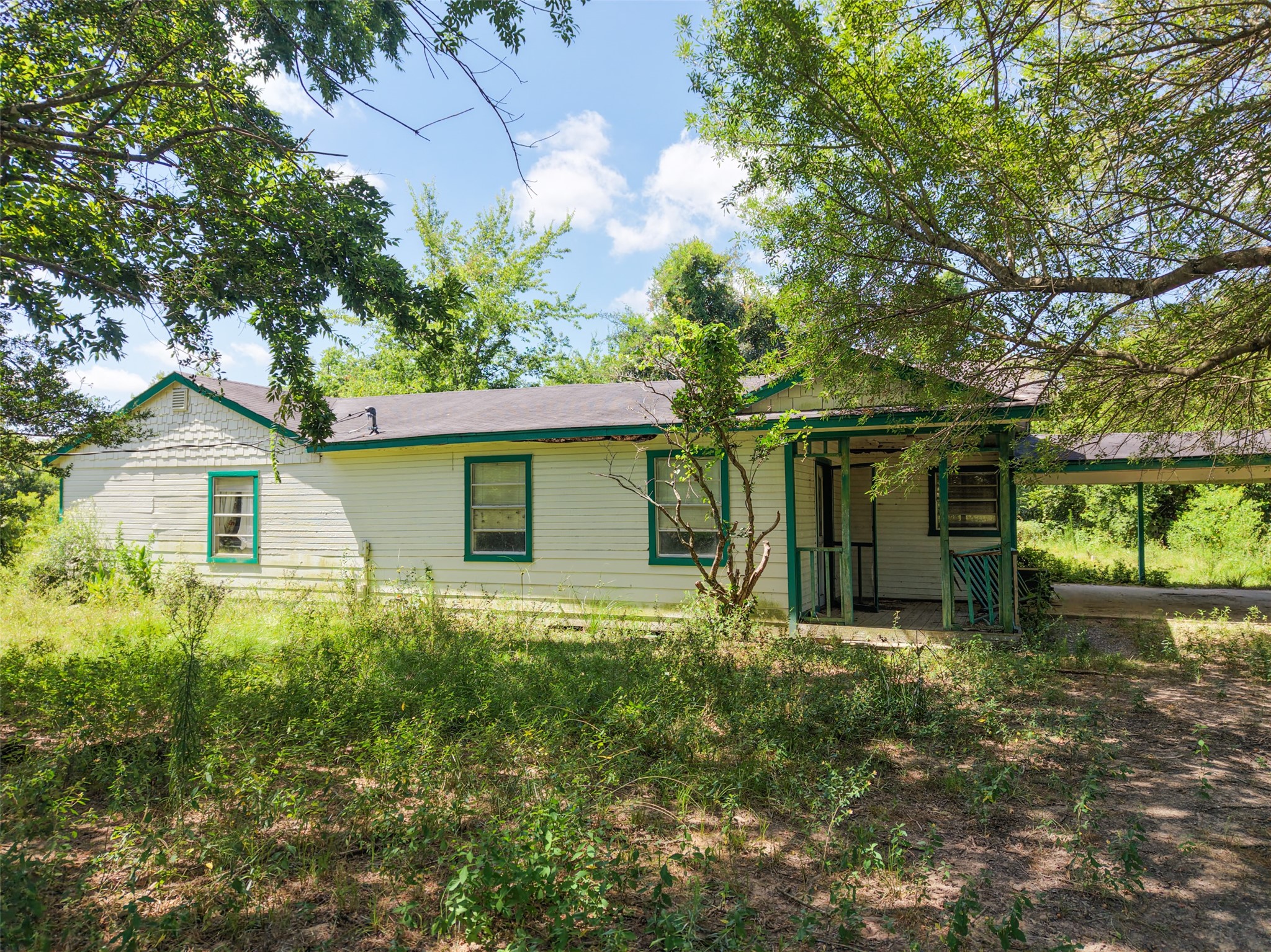 28619 Barry Lane Waller, TX 77484 - Photo 13 of 28 Existing home tucked beneath mature shade trees, offering a quiet country setting with plenty of room to enjoy the outdoors.