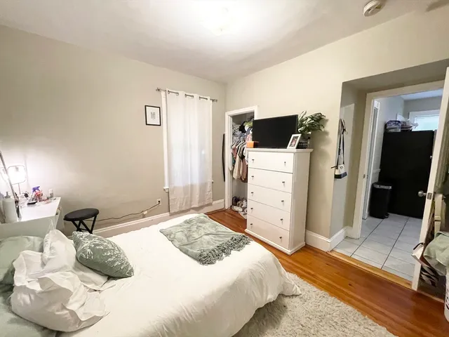 a bedroom with a bed and a television