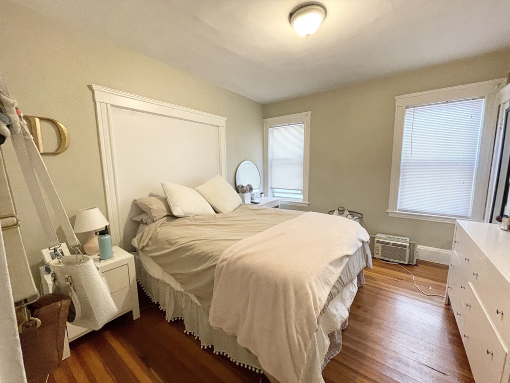 9 Taft Street, Unit 1 Boston, MA 02125 - Photo 13 of 15 a bedroom with a bed and wooden floor