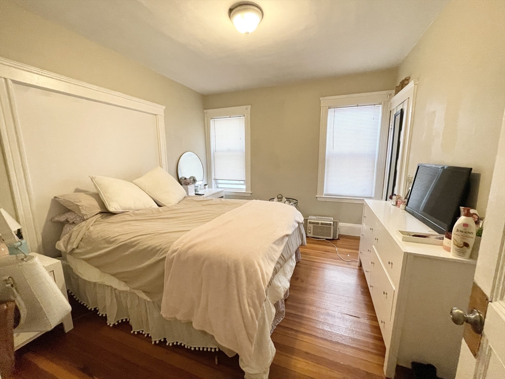 9 Taft Street, Unit 1 Boston, MA 02125 - Photo 14 of 15 a bedroom with a bed and wooden floor