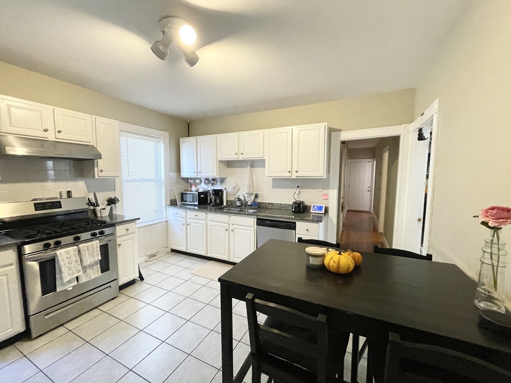 9 Taft Street, Unit 1 Boston, MA 02125 - Photo 2 of 15 a kitchen with a sink appliances and cabinets