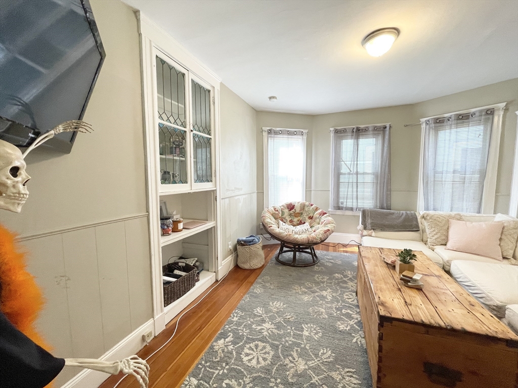 9 Taft Street, Unit 1 Boston, MA 02125 - Photo 3 of 15 a living room with furniture and a window