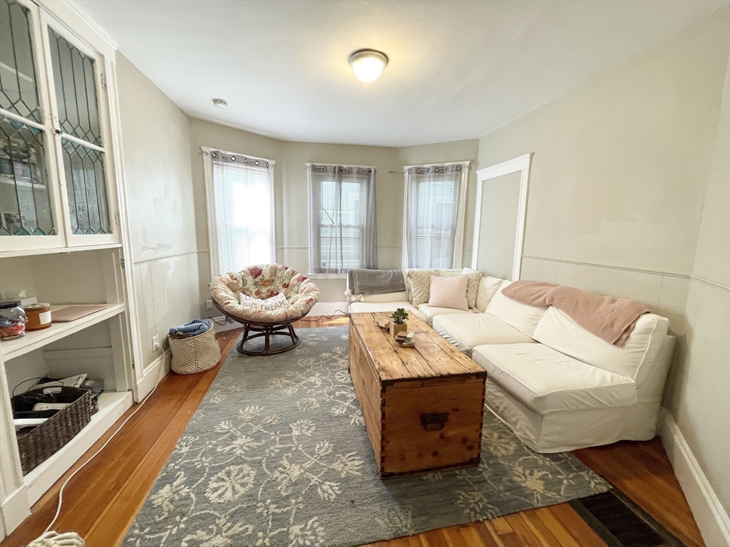 9 Taft Street, Unit 1 Boston, MA 02125 - Photo 4 of 15 a living room with furniture and a large window