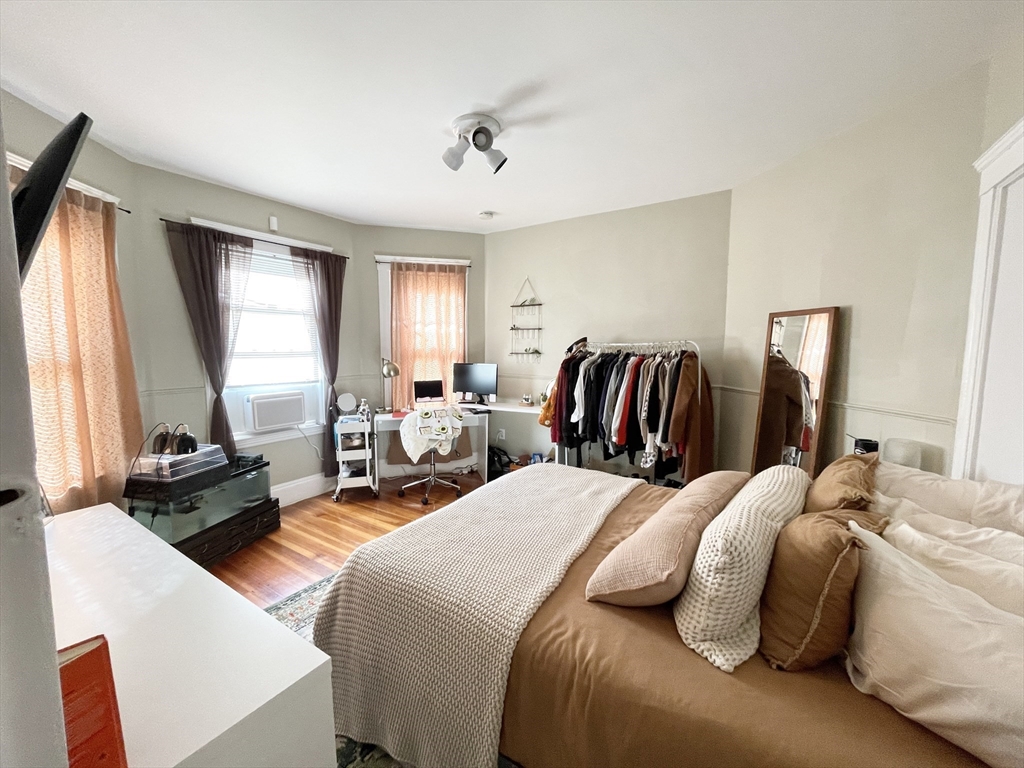 9 Taft Street, Unit 1 Boston, MA 02125 - Photo 6 of 15 a bedroom with two beds and a large mirror