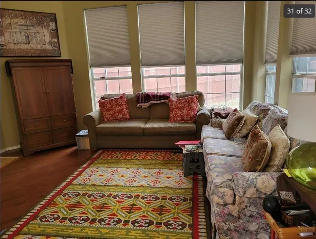 a living room with furniture and a rug