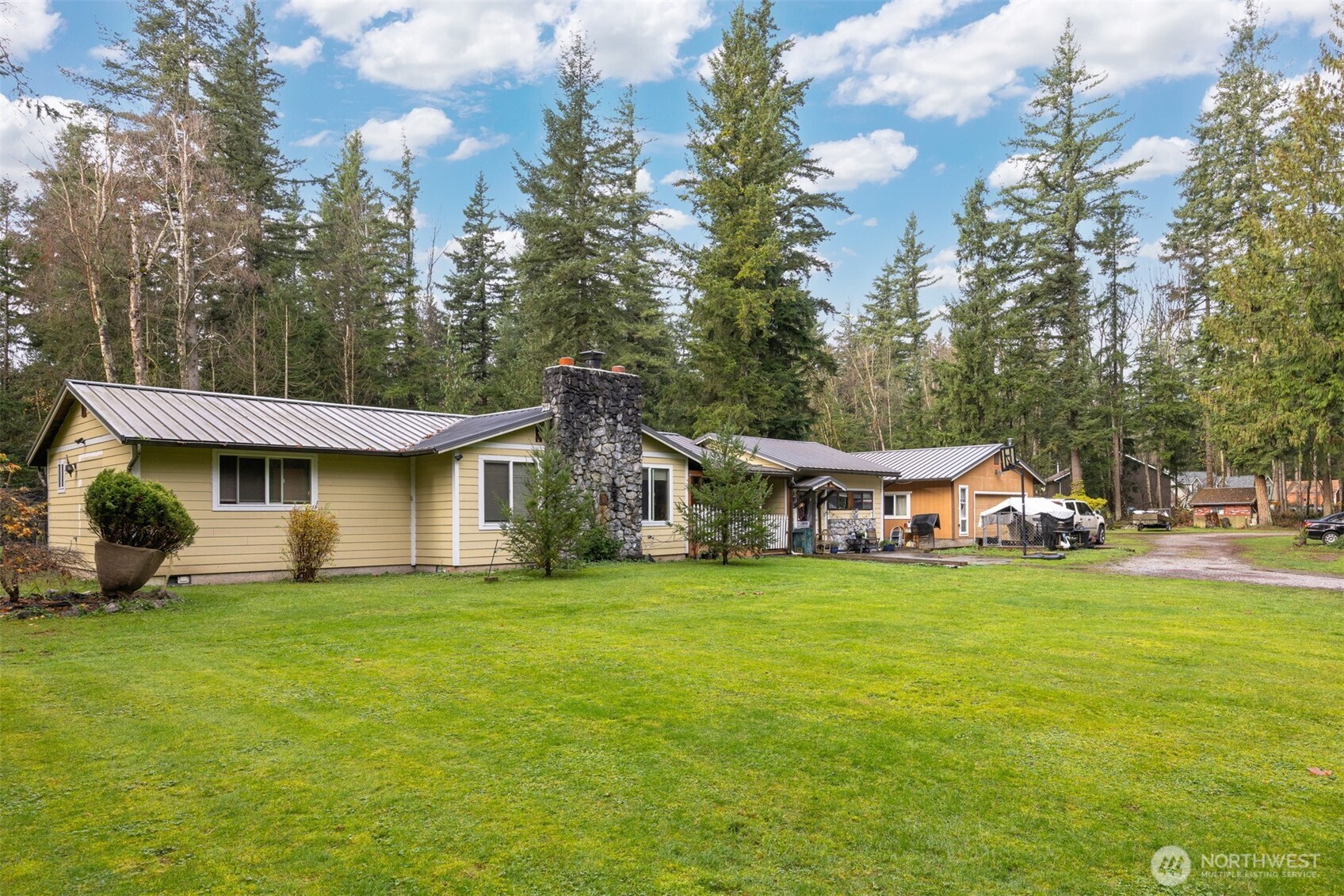 a view of a house with a yard and sitting area