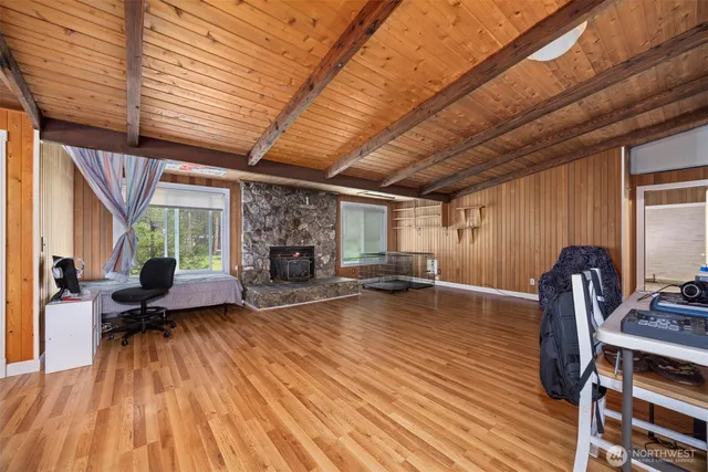 a living room with furniture a wooden floor and a fireplace