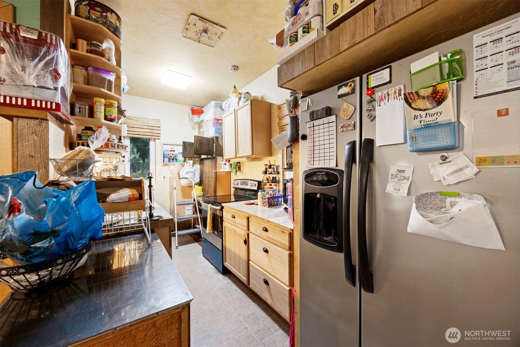 3630 Sorenson Road Everson, WA 98247 - Photo 27 of 39 a kitchen with stainless steel appliances a refrigerator a stove and a dining table