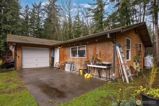 a view of a house with backyard sitting area and garden