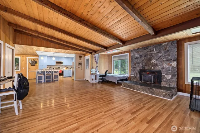 a living room with furniture a fireplace and wooden floors