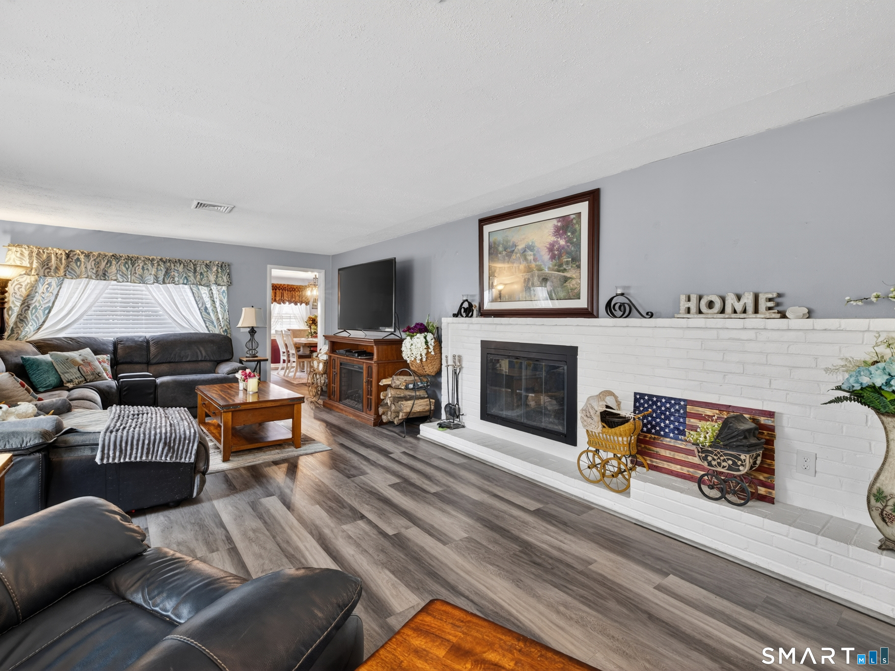 235 Scotland Road Norwich, CT 06360 - Photo 13 of 31 a living room with furniture a fireplace and a flat screen tv