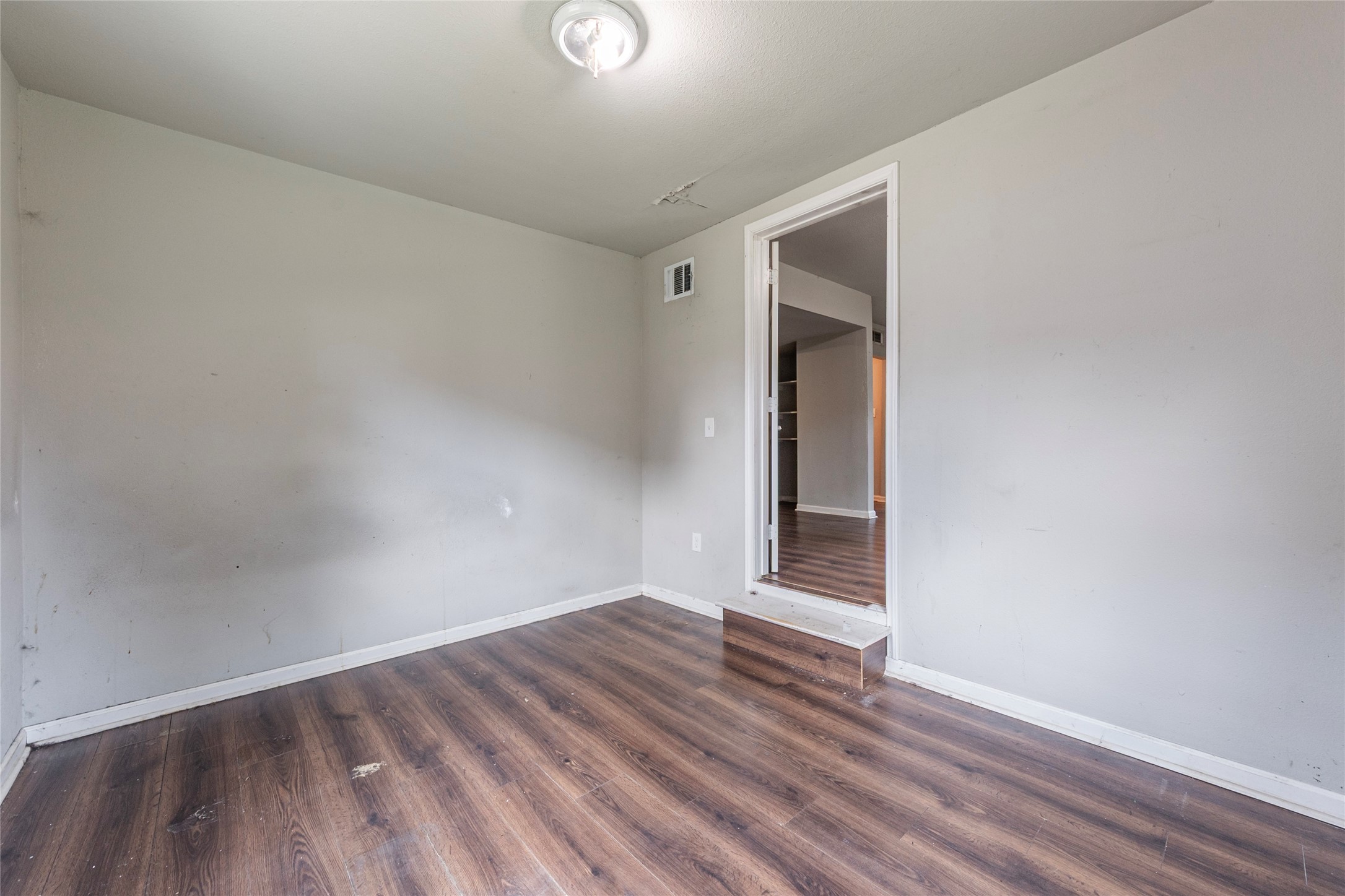2801 Virginia Street, Unit B Baytown, TX 77520 - Photo 11 of 20 a view of an empty room with wooden floor and closet