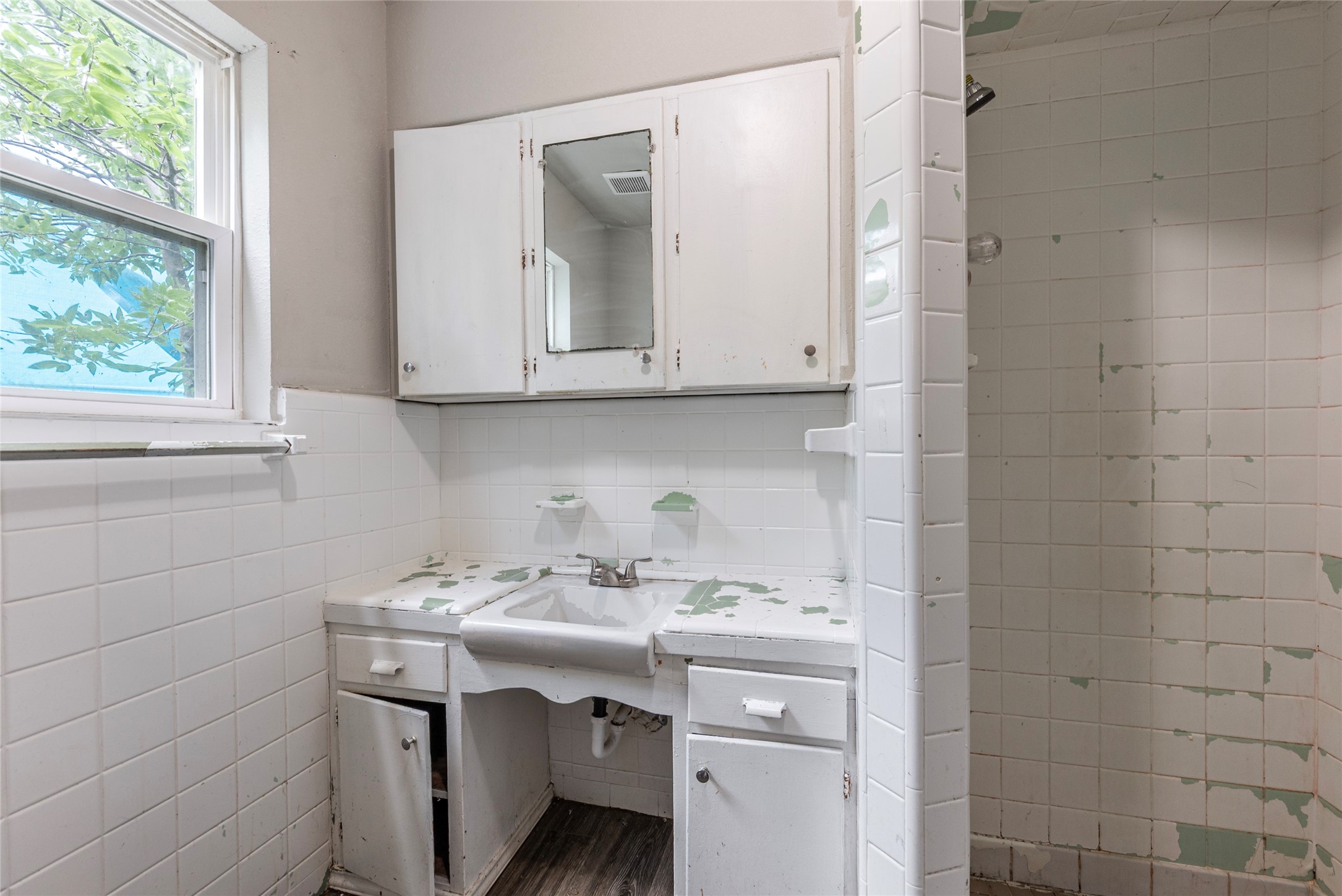 2801 Virginia Street, Unit B Baytown, TX 77520 - Photo 16 of 20 a bathroom with a sink and a mirror