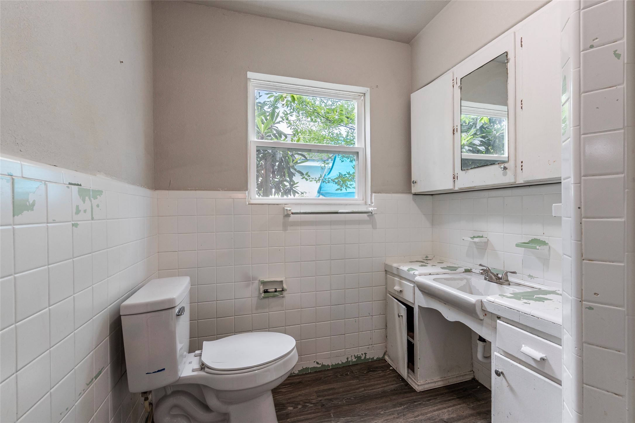 2801 Virginia Street, Unit B Baytown, TX 77520 - Photo 17 of 20 a bathroom with a toilet sink and window