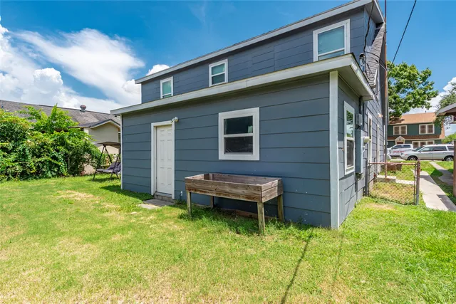 a view of a house with a yard and sitting area